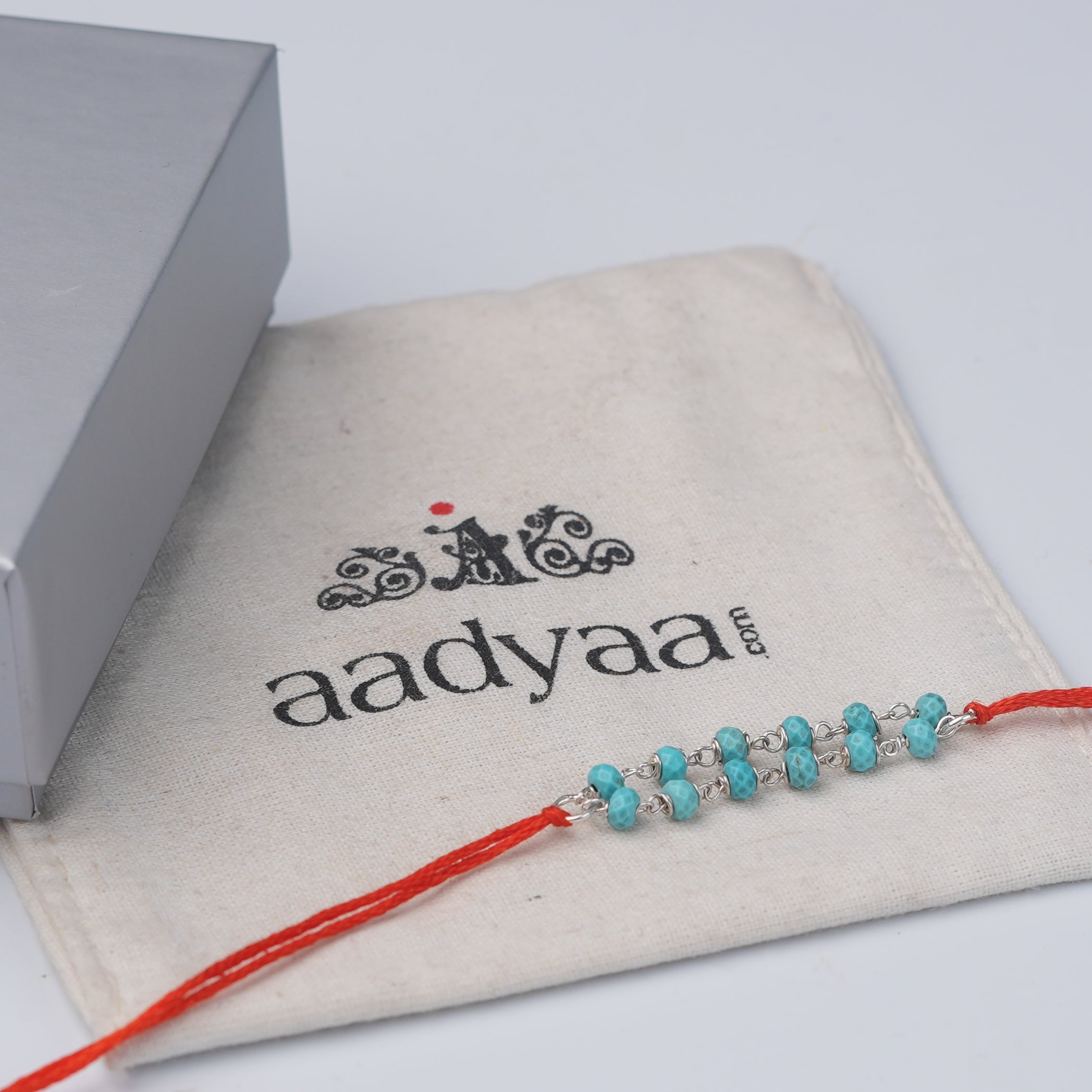 Turquoise Ganthan Rakhi (Project Handmade)