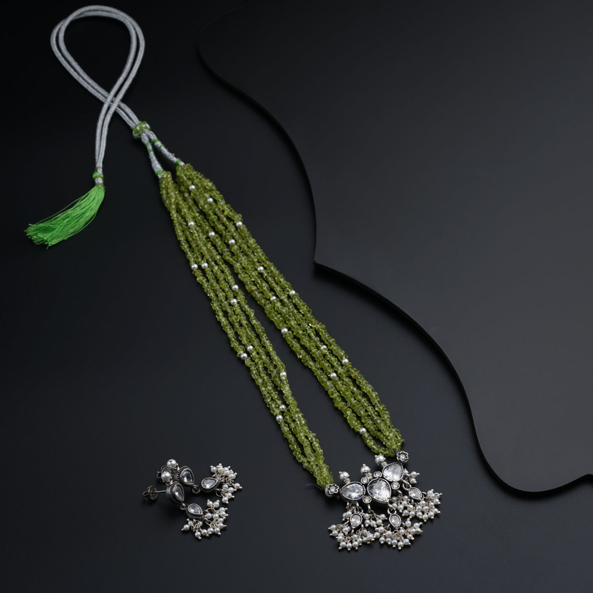 a pair of green beaded necklaces and earrings