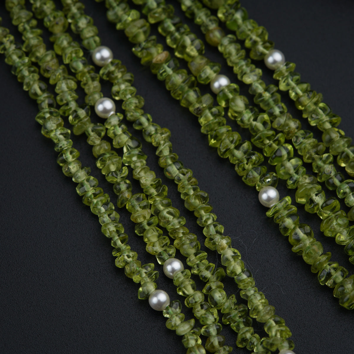a close up of a string of green beads