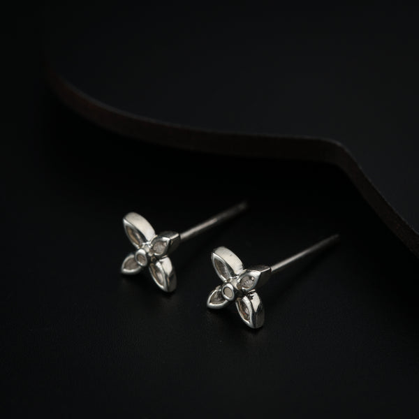 Silver flower earrings with dark backdrop