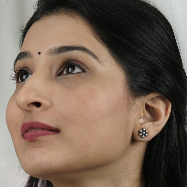 Model styling silver kudi studs with modern ethnic look