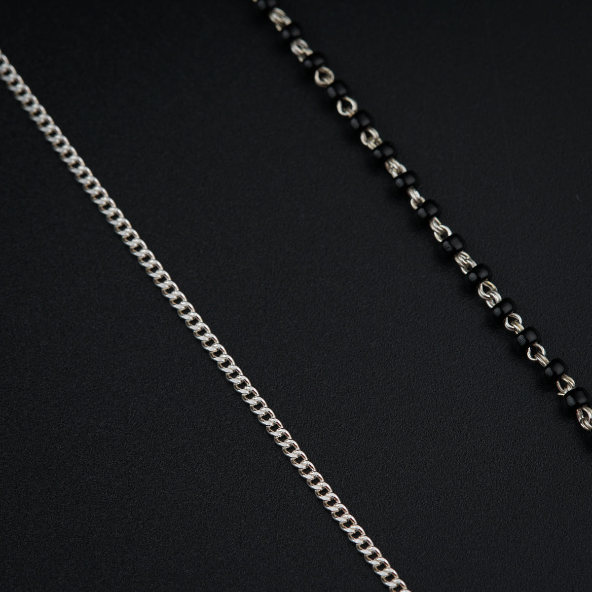 a close up of a chain on a black surface