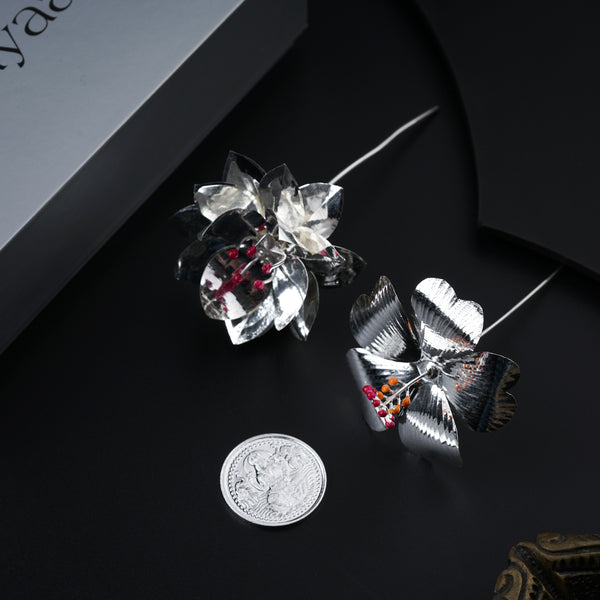 Close-up of silver butterfly accessory with colorful beads