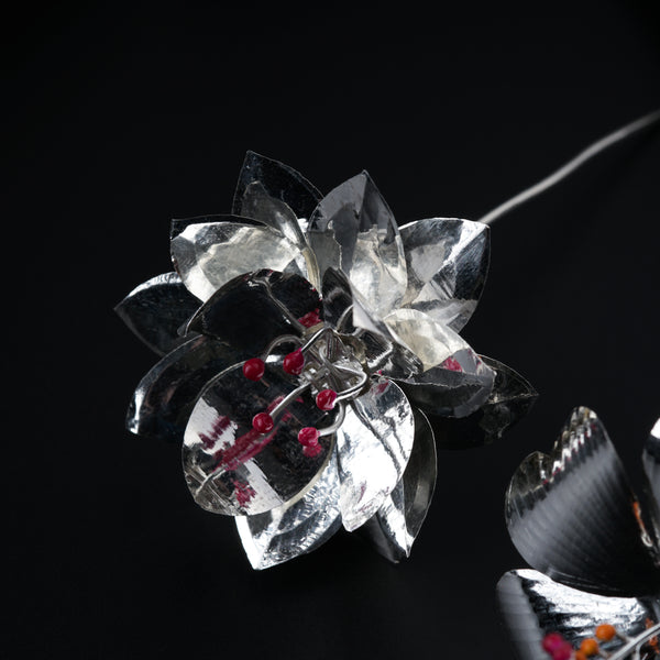 Silver coin with intricate design for gift set packaging