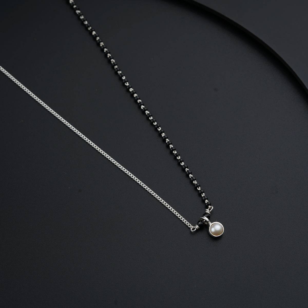 a black and white photo of two necklaces