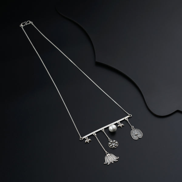 a pair of necklaces on a black background
