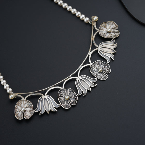a close up of a necklace on a black surface