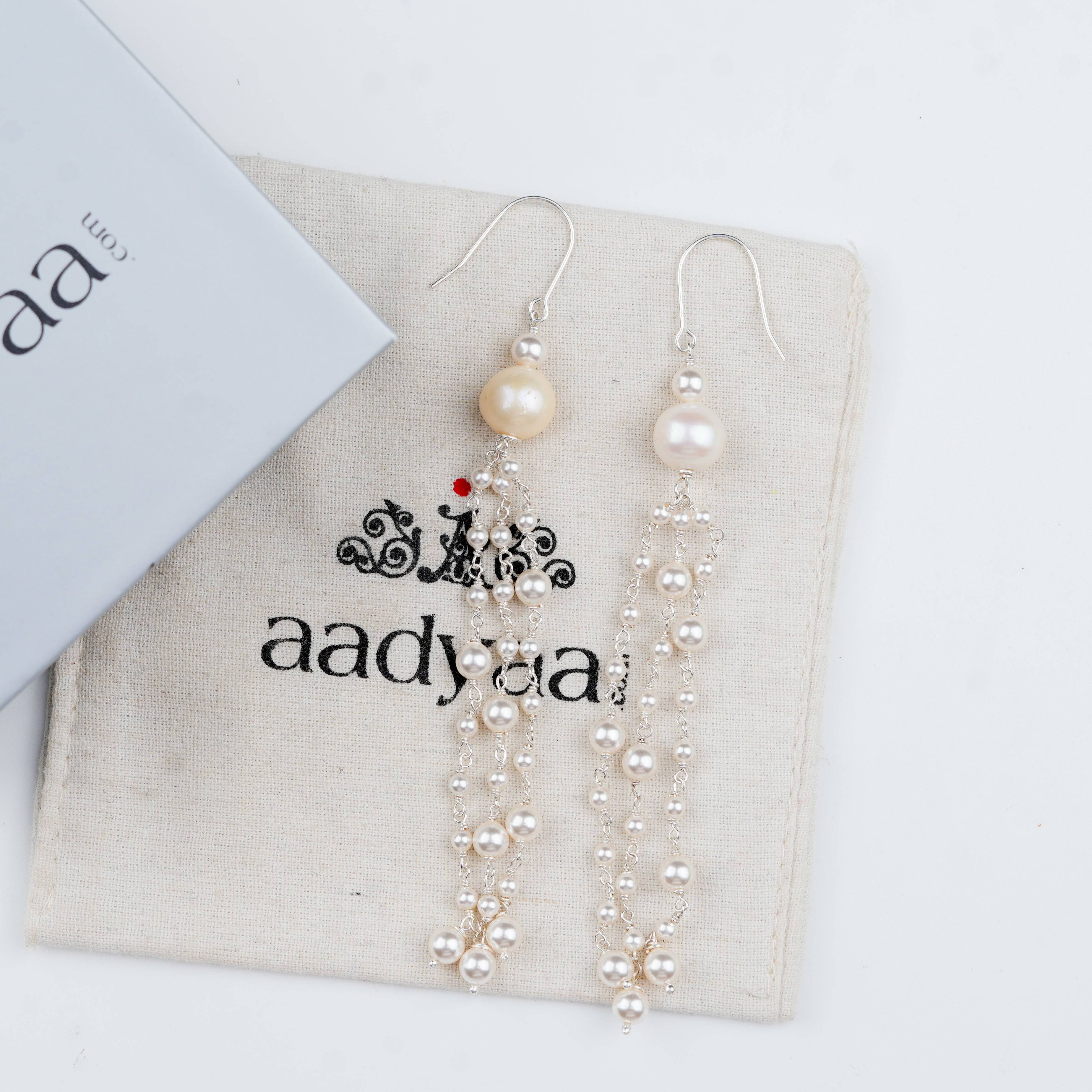 Sterling silver earrings with lustrous pearls and flow-inspired design