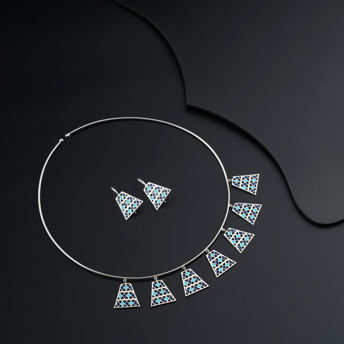 a necklace and earring made of silver and blue glass