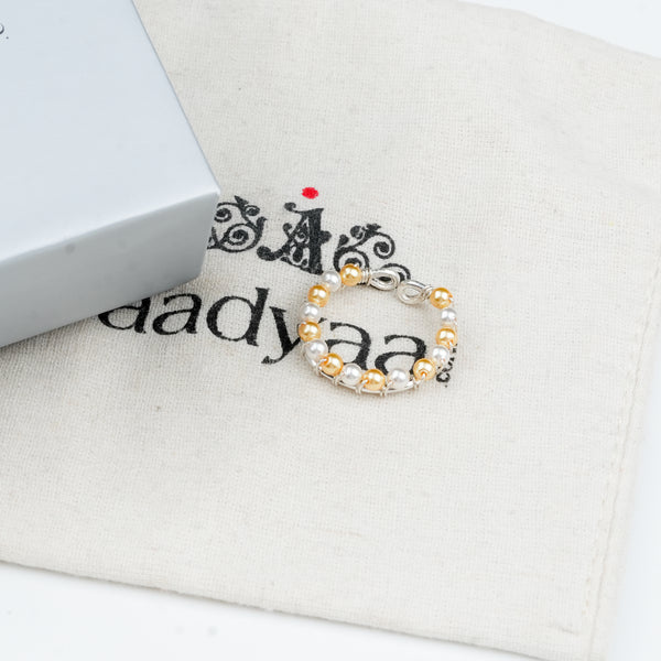 Sterling silver ring with golden and white pearl detailing