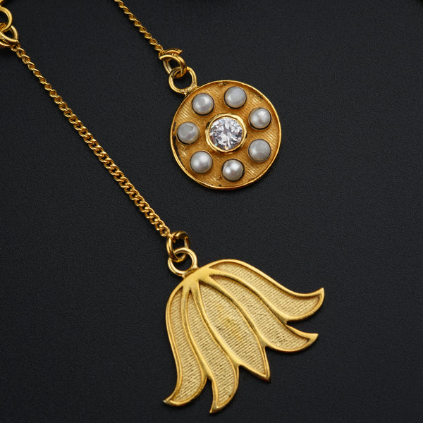 a close up of two necklaces on a black surface