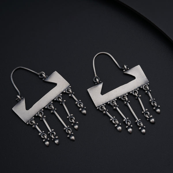 a pair of silver earrings with dangling beads