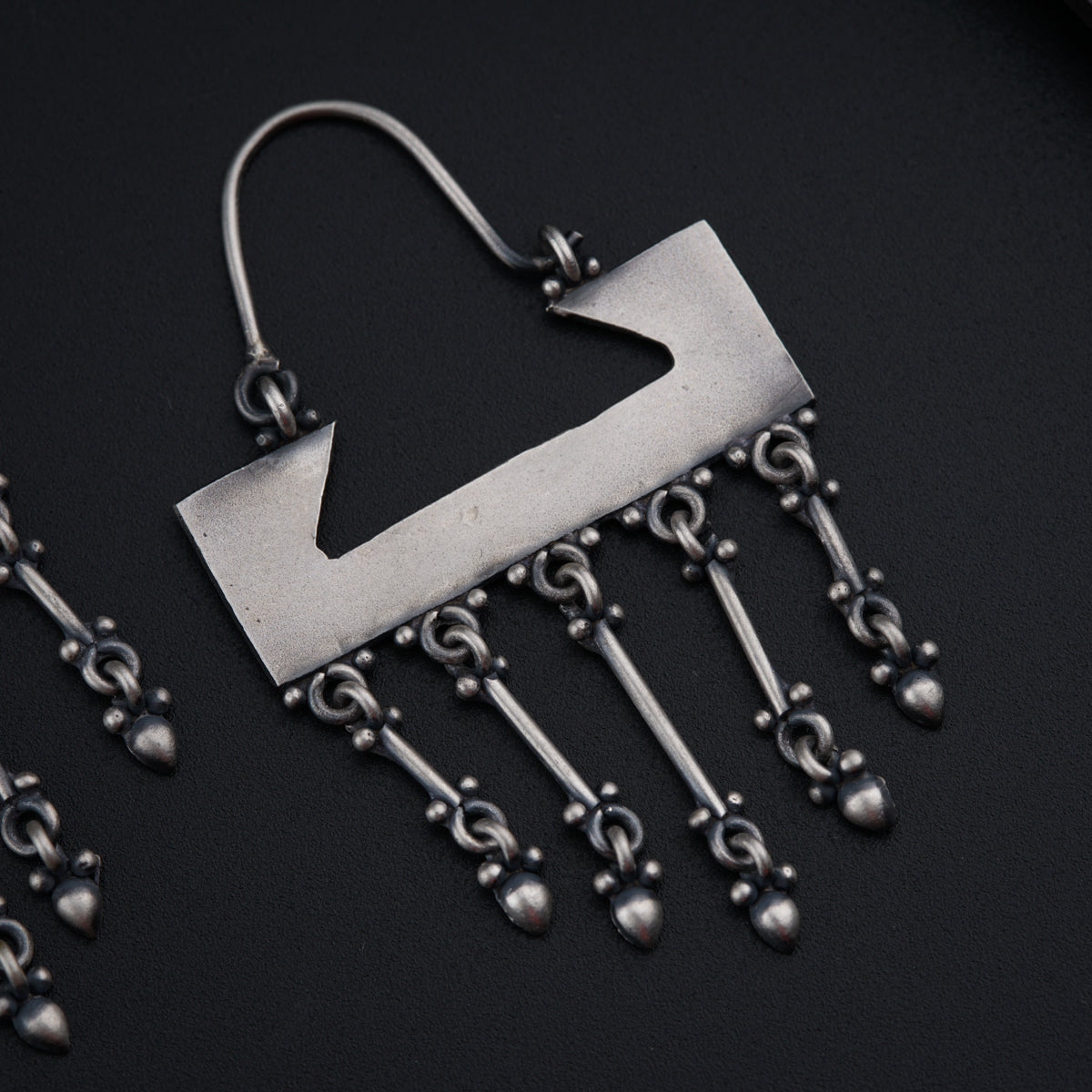 a pair of earrings with a metal hook