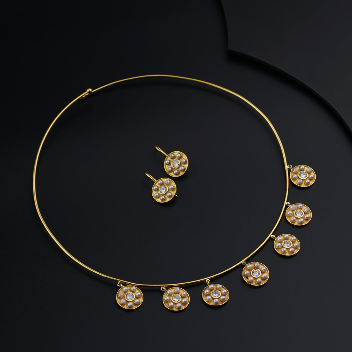 a gold necklace and earring set with diamonds