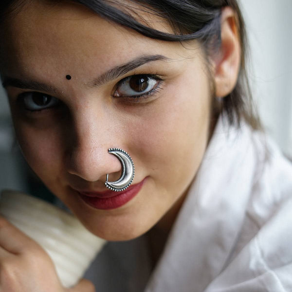 a woman with a nose ring on her nose