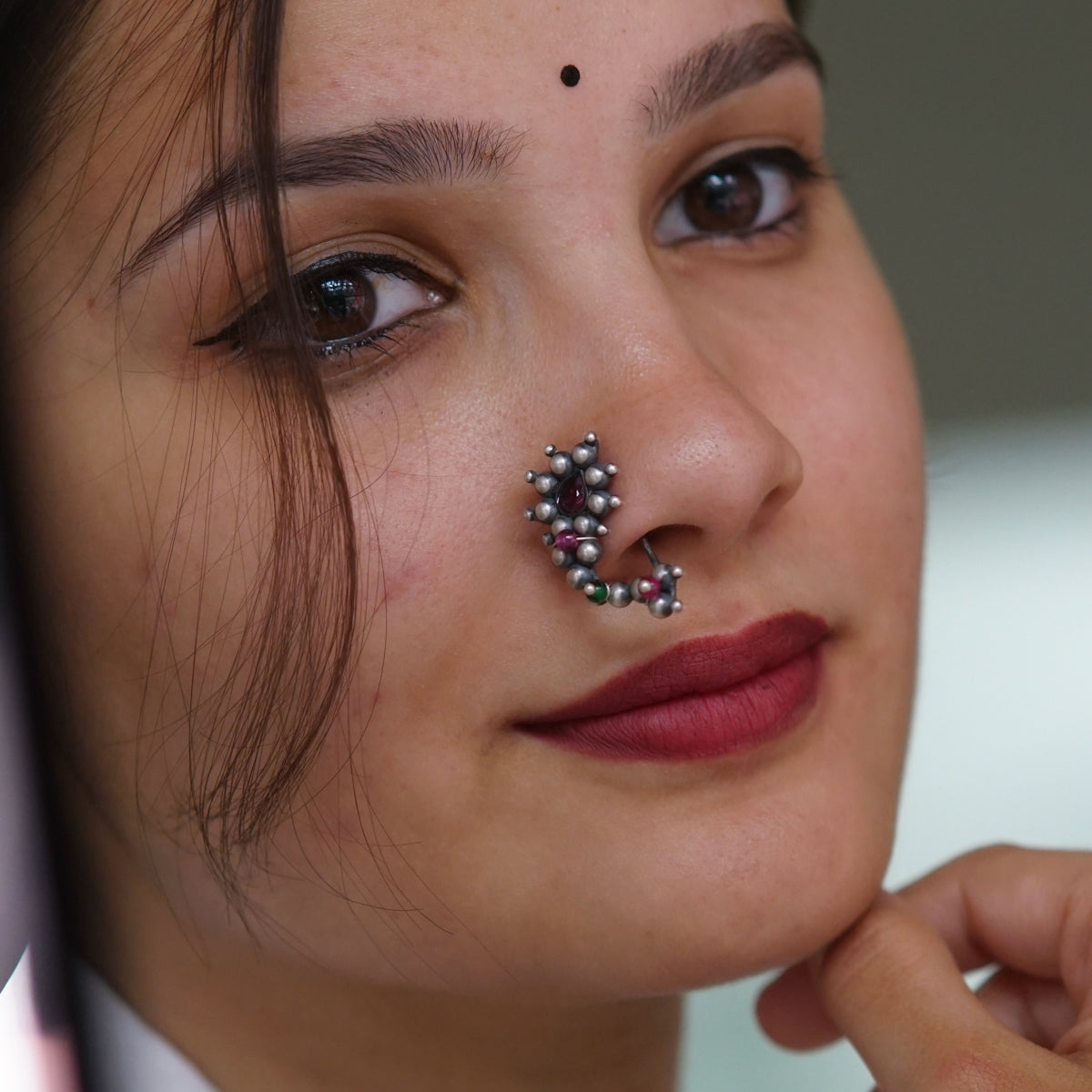 a close up of a woman with a nose piercing