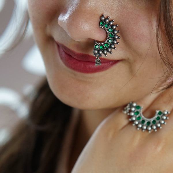 a close up of a woman with a nose piercing