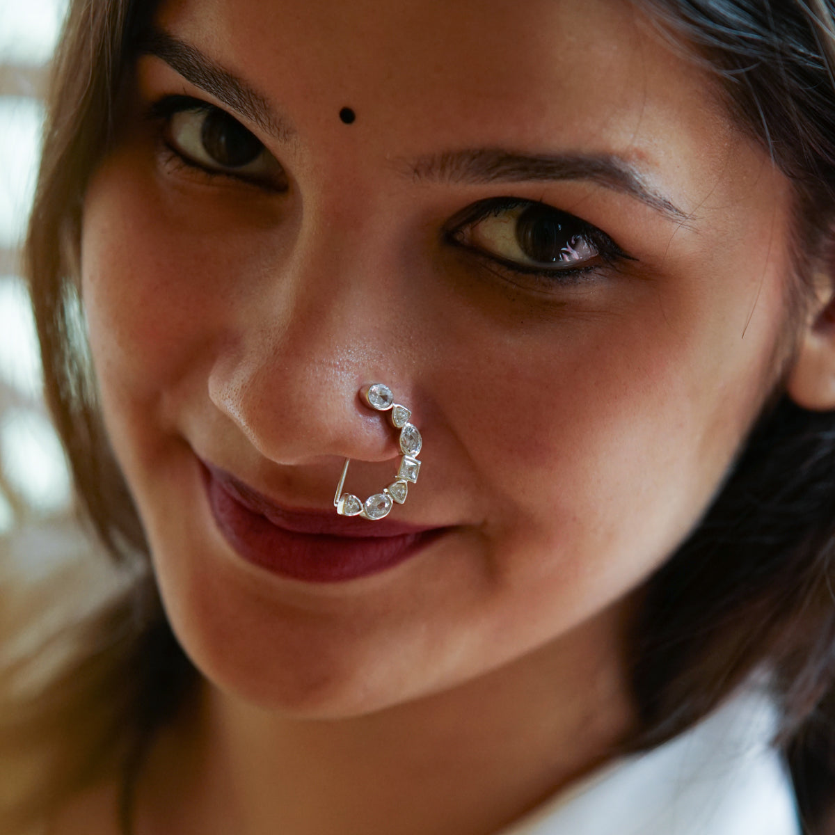 a woman with a nose ring and a nose piercing