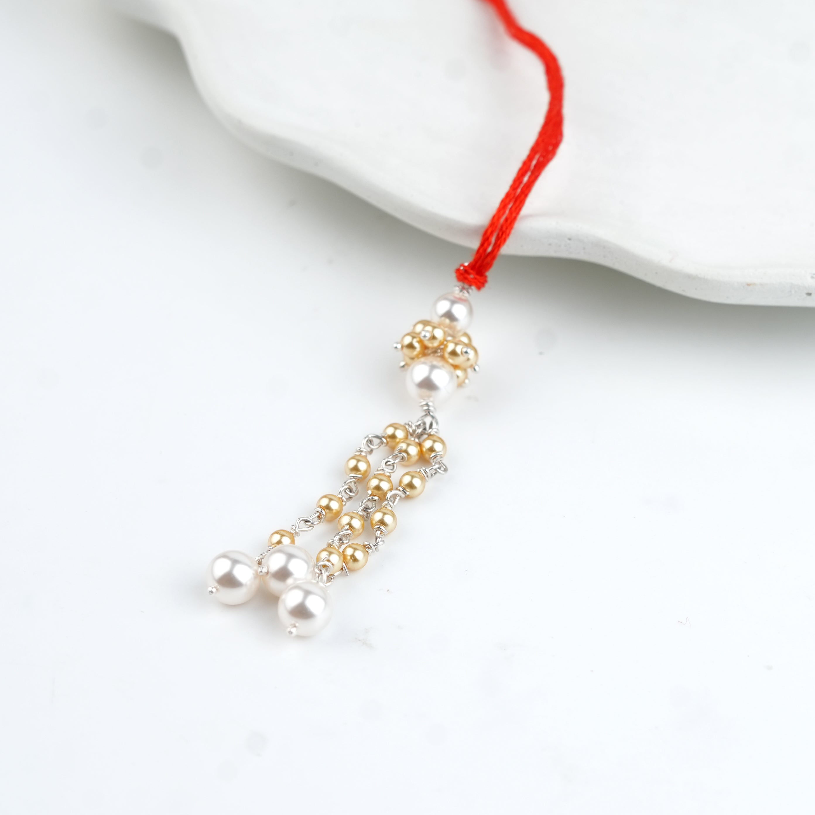 Golden & White Pearl Handmade Silver Lumba Rakhi