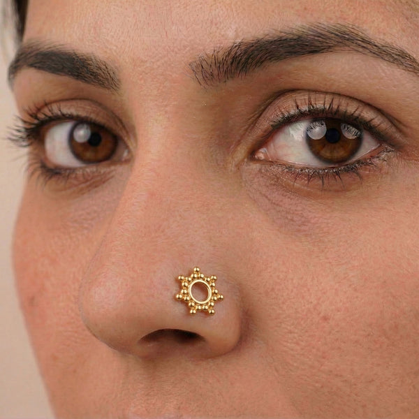Gold nose pin on nose