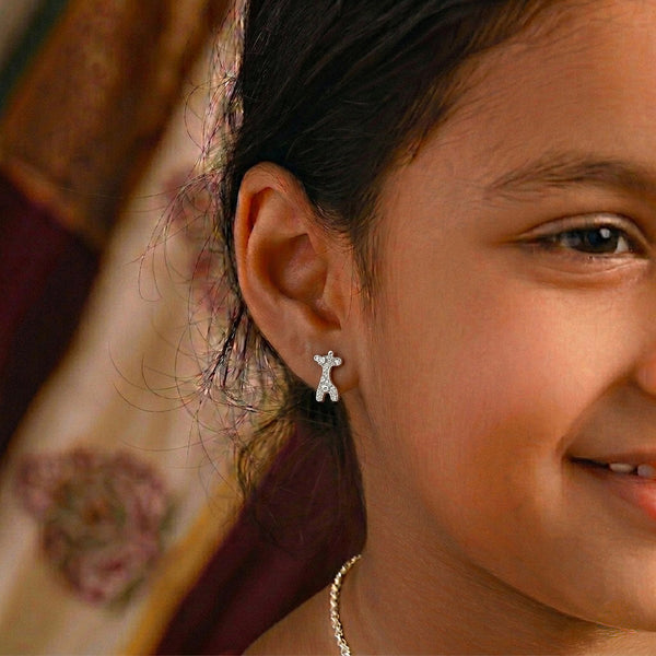 Woman wearing silver giraffe earrings