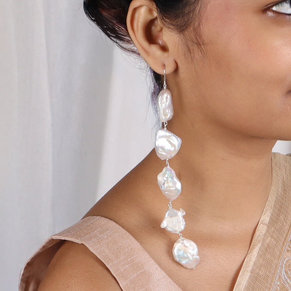 Model wearing baroque pearl earrings with silver hooks