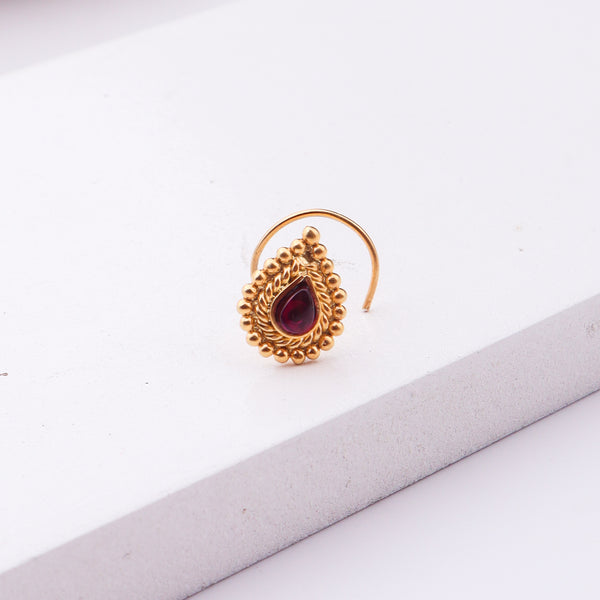 Gold-plated nose pin with red stone and intricate design for pierced noses