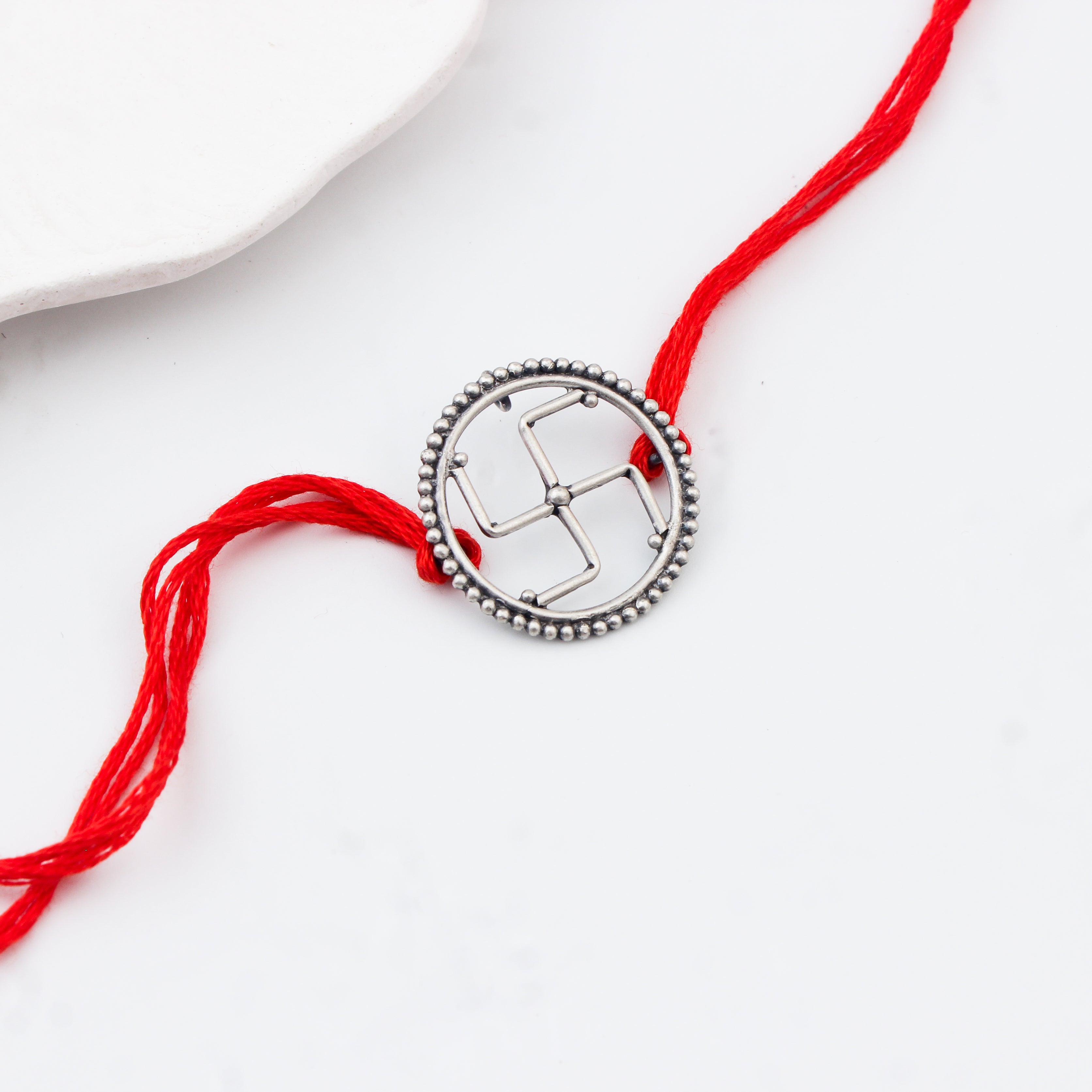 Handcrafted Silver Rakhi/Pendant: Swastik