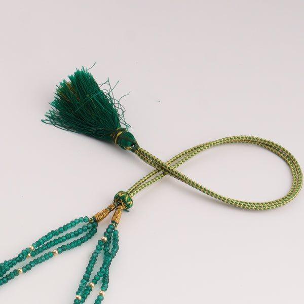 Green beaded tassel necklace with gold accents