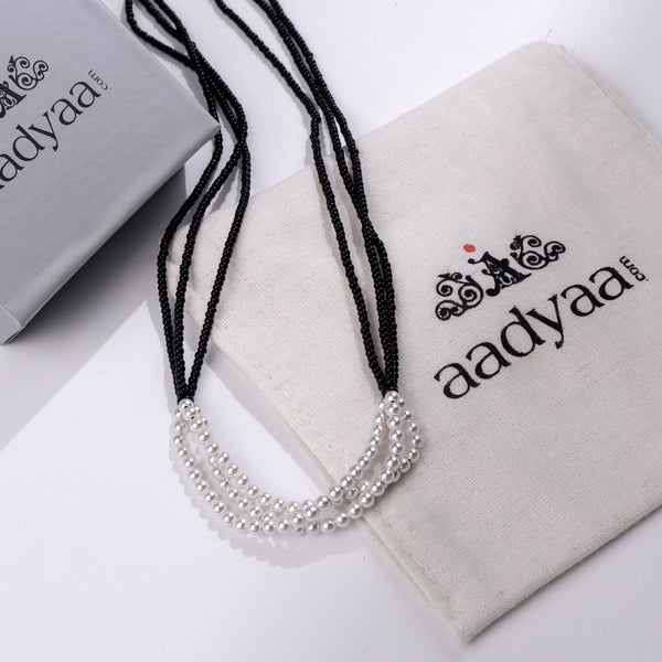 White Pearl Bunch Mangalsutra with black beads and silver pearls on Aadyaa packaging