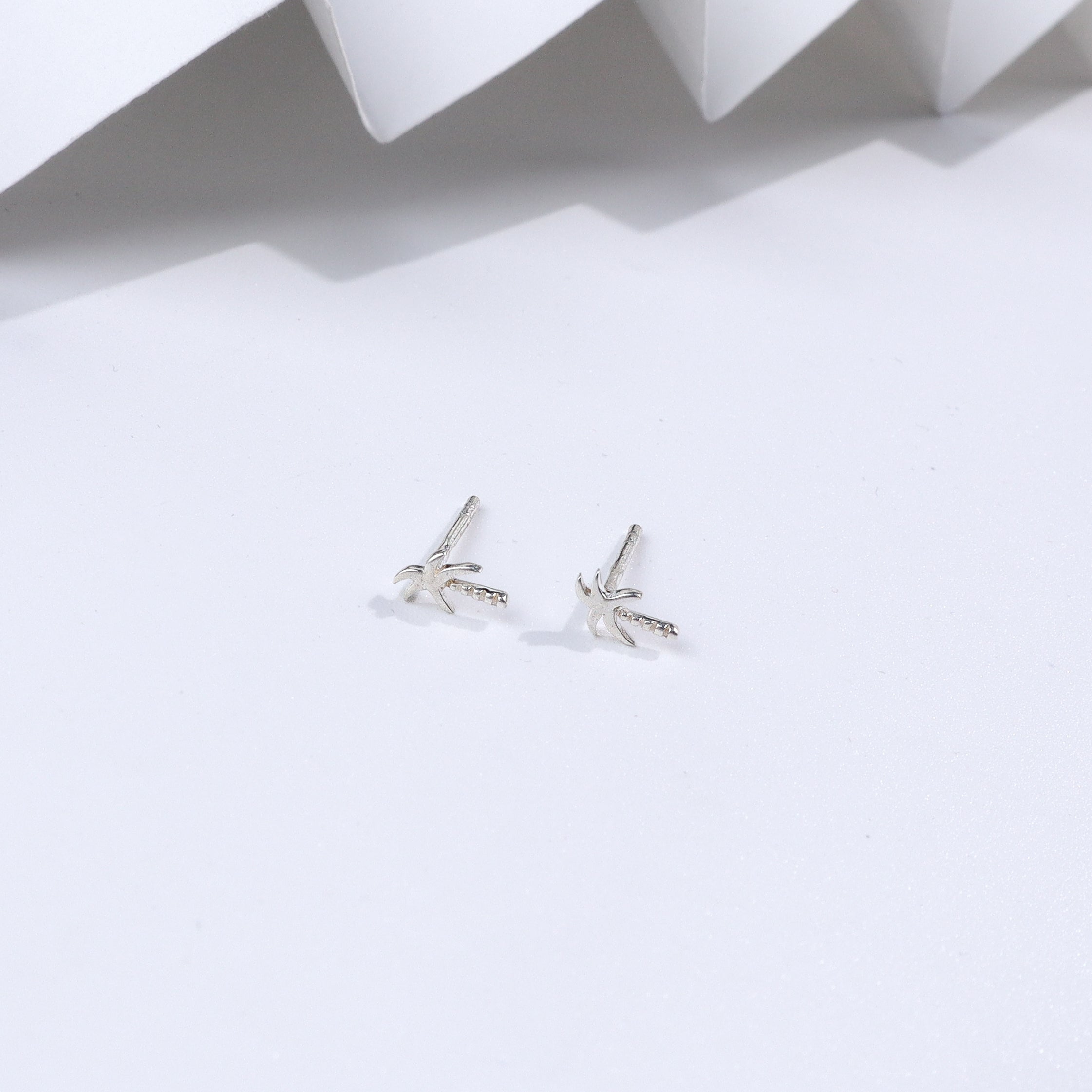 Silver Coconut Tree Stud earrings on white background