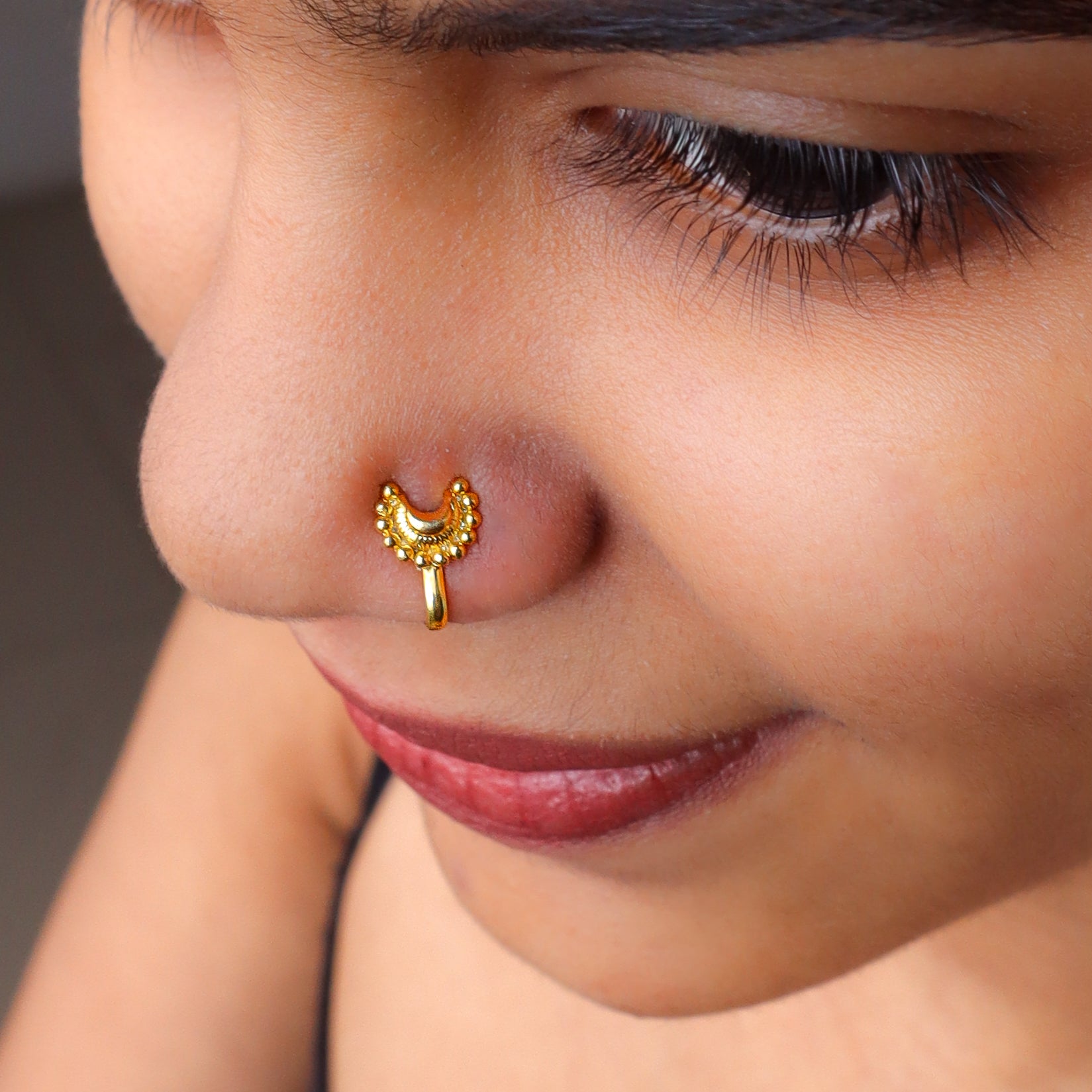 Gold Chandrakor nose pin on nose