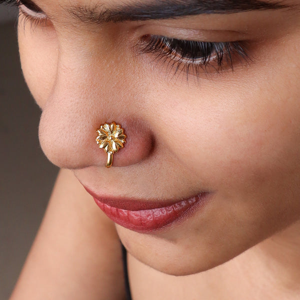 Gold floral nose pin on nose
