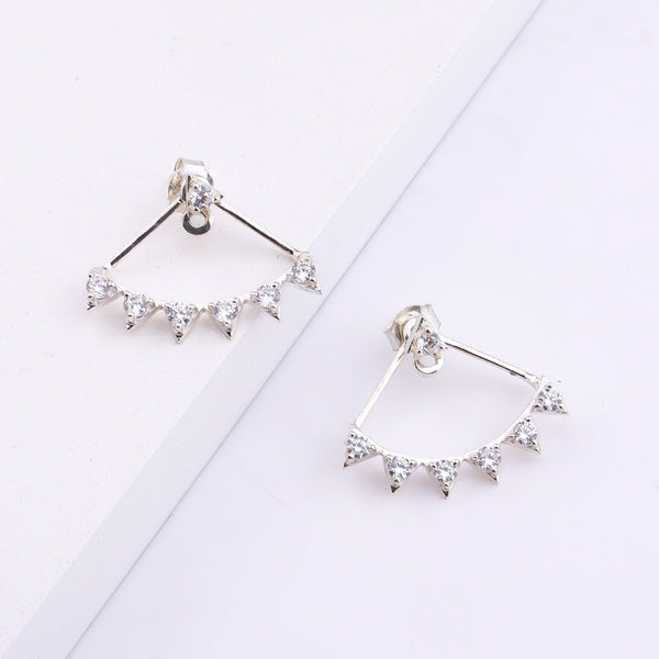 Silver earrings with clear stones displayed on white background