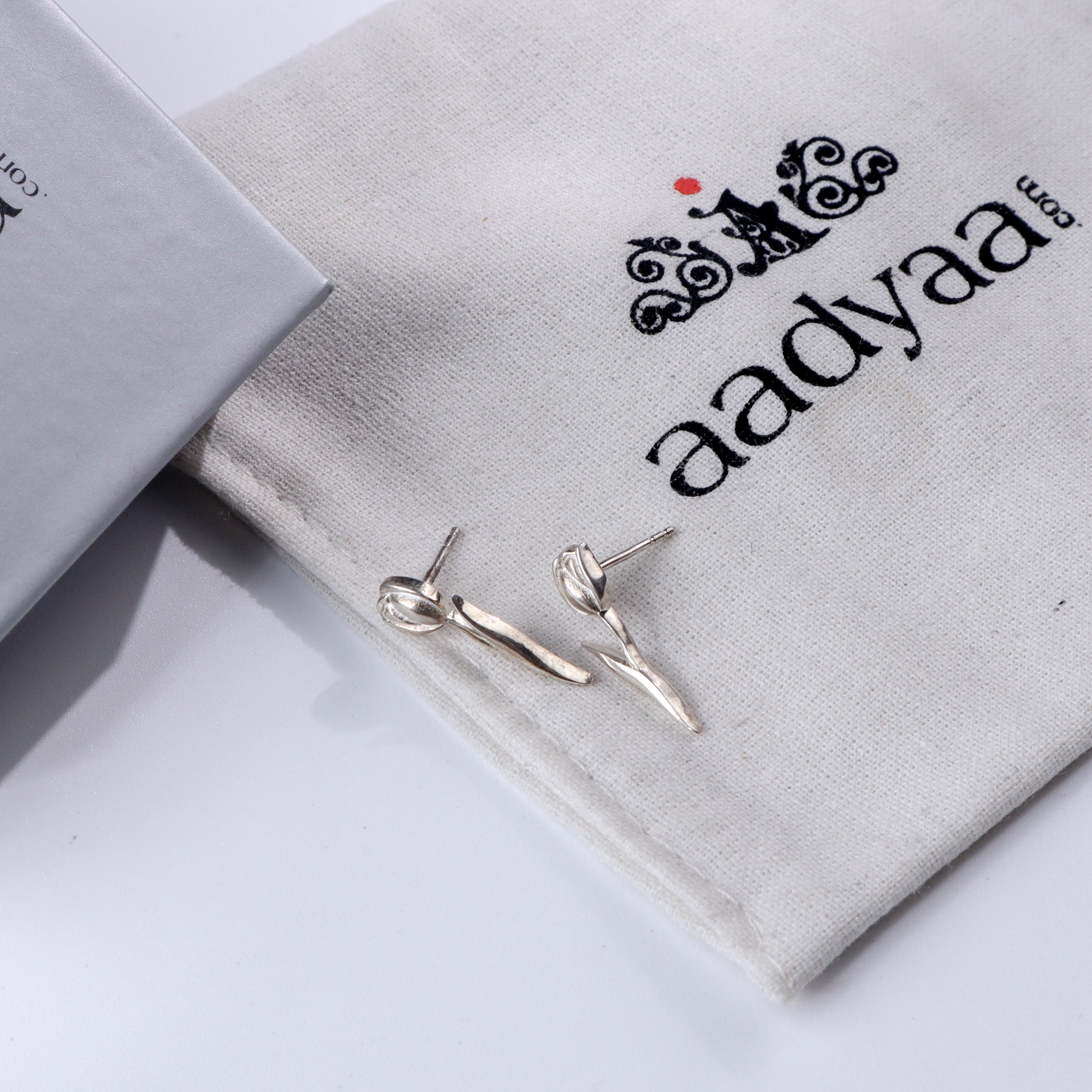 Silver Tulip Earrings on fabric pouch