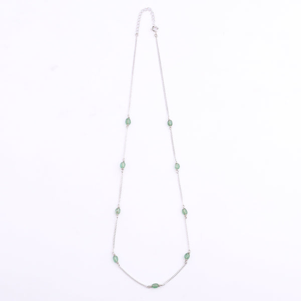 Close-up of silver chain with green quartz beads