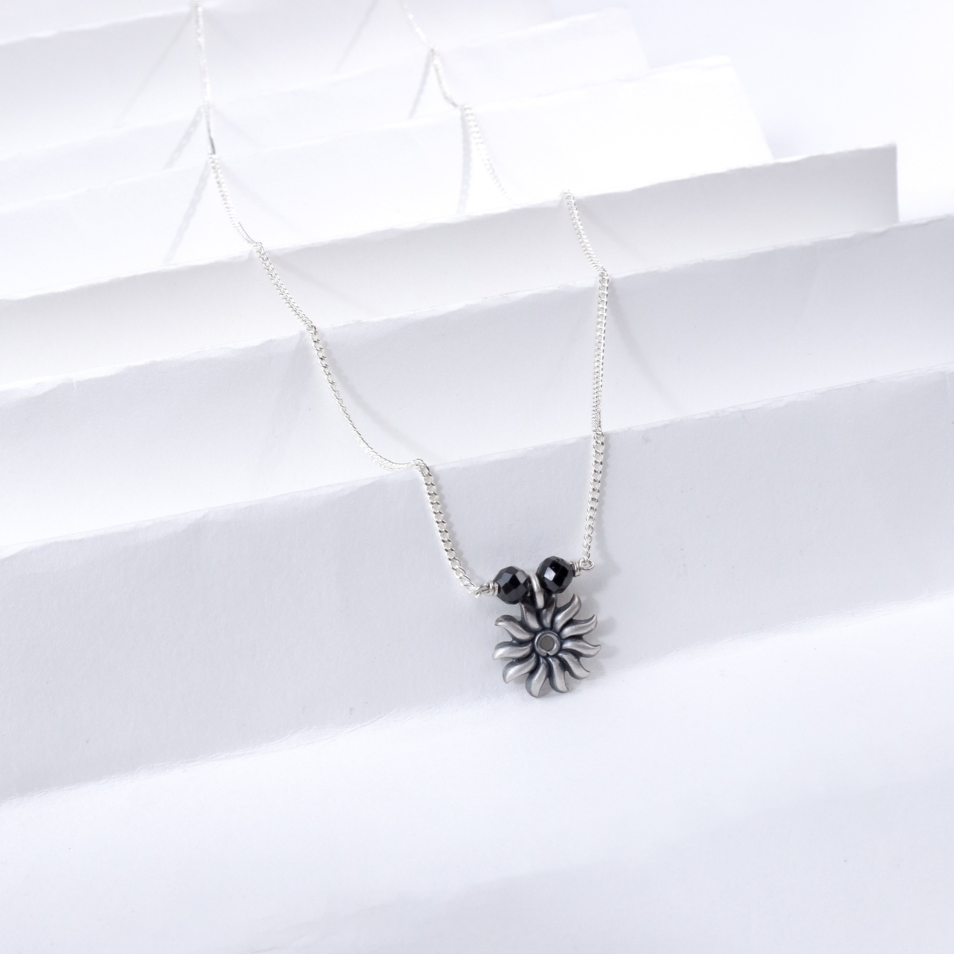 Silver Sun Charm Necklace with Black Beads
