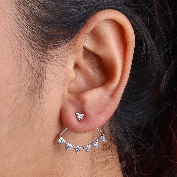 Close-up of silver earrings with clear stones worn on ear