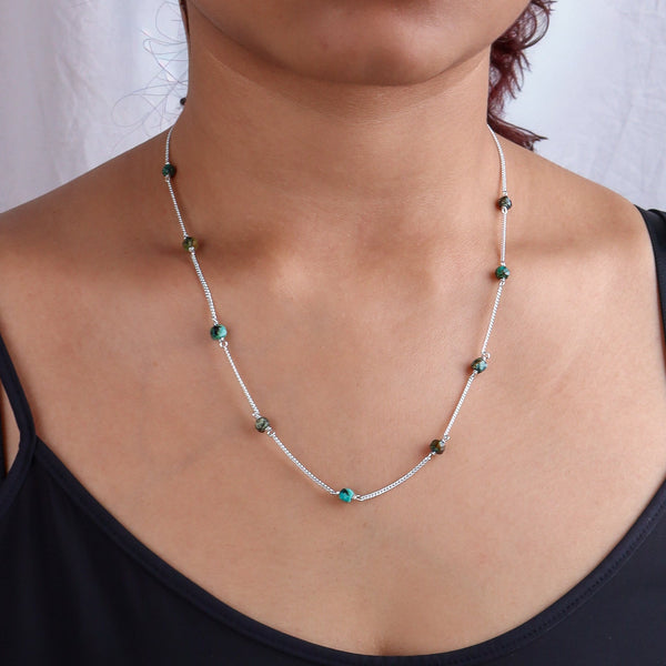 Silver necklace with turquoise and green beads on model