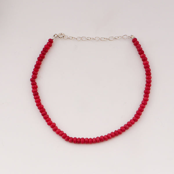 Close-up of red sapphire anklet chain