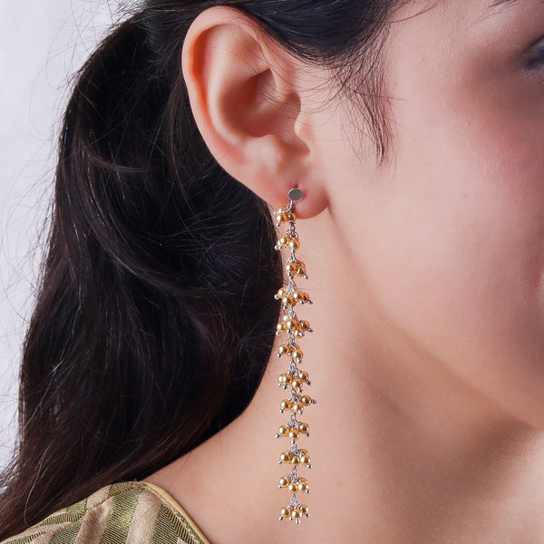 Long pearl drop earrings with gold and silver accents