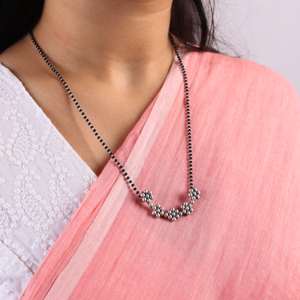 Silver 5 Kudi Mangalsutra Set worn with matching earrings on a model