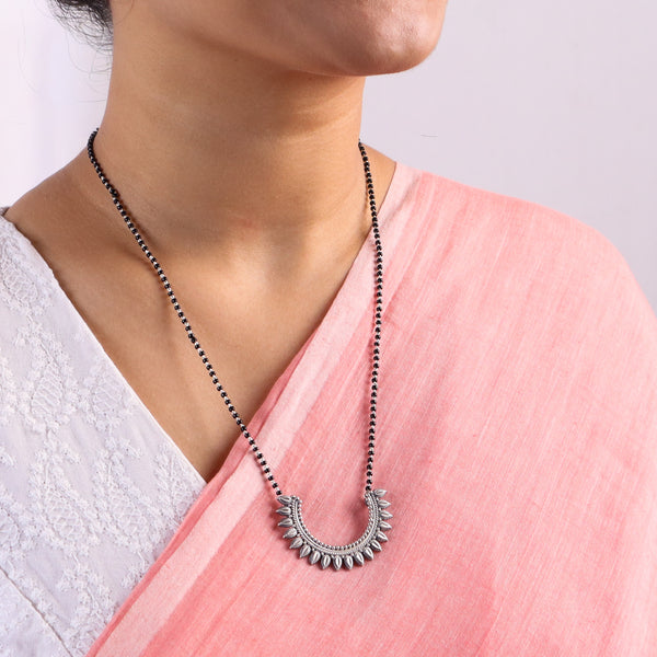 Woman wearing black beaded mangalsutra necklace