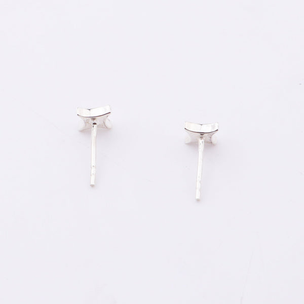 Sterling silver star enamel stud earrings on white background, jewelry detail