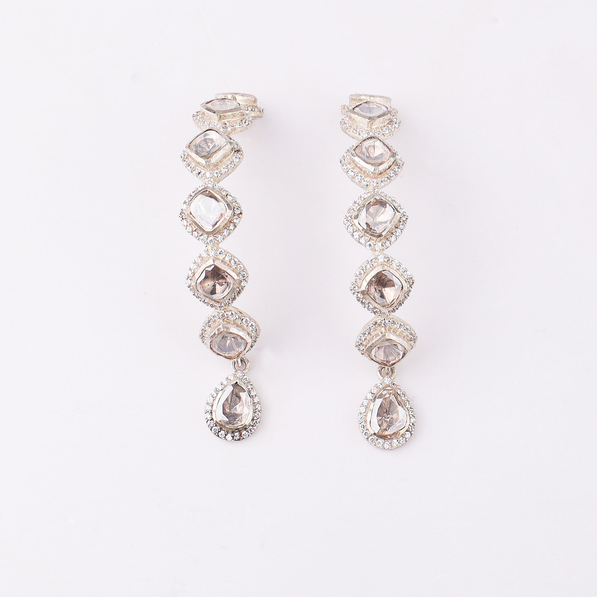 Fashion jewelry with moissanite stones on white surface