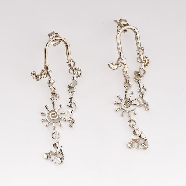 Silver earrings with Warli motifs and dangling sun and dancer charms