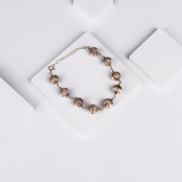 Silver beaded bracelet on white background