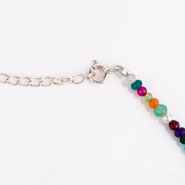 Flat-lay silver charms necklace with multicolour stones