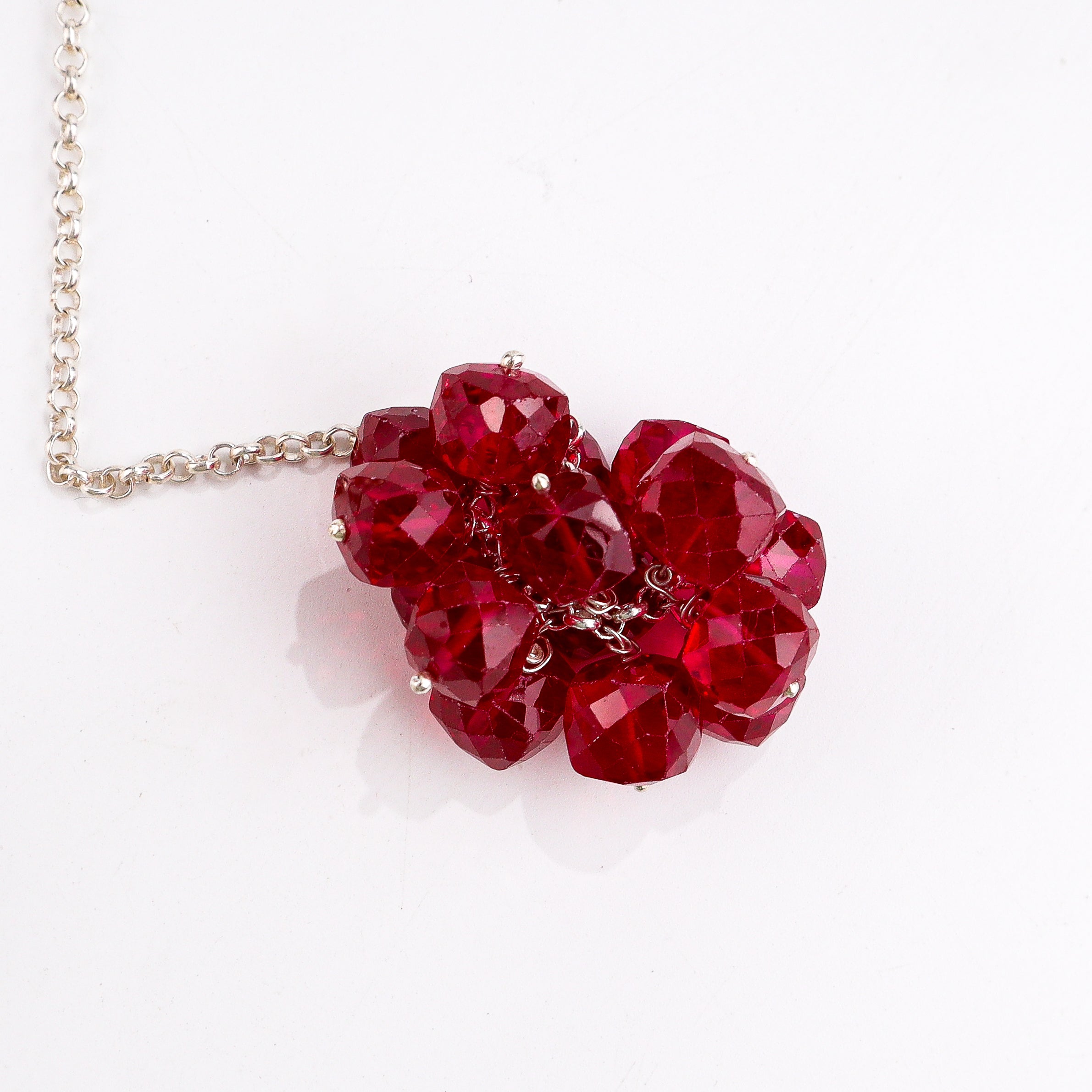 Model wearing silver tie and wear necklace with ruby for festive styling