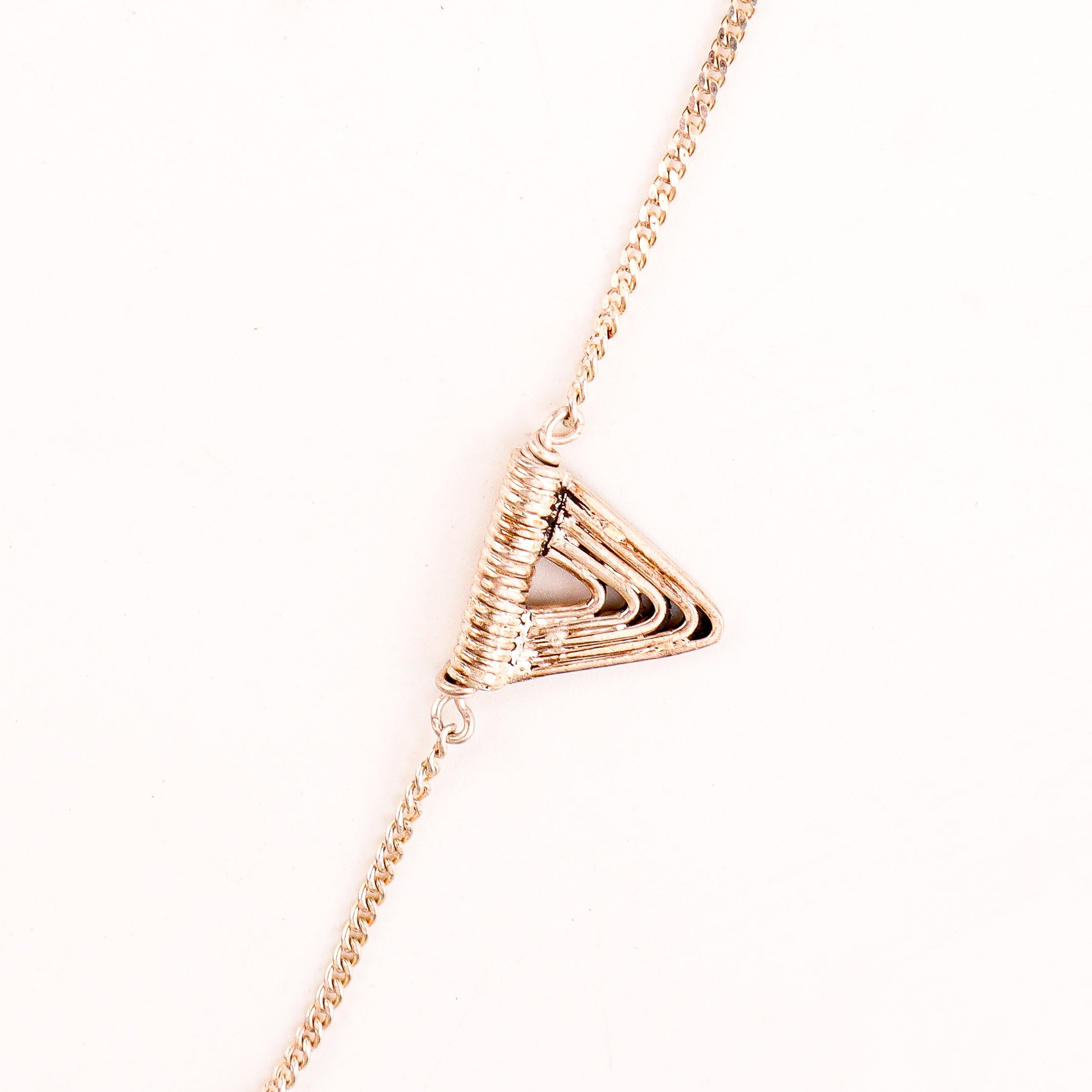 wear silver spiral triangle necklace short for modern styling